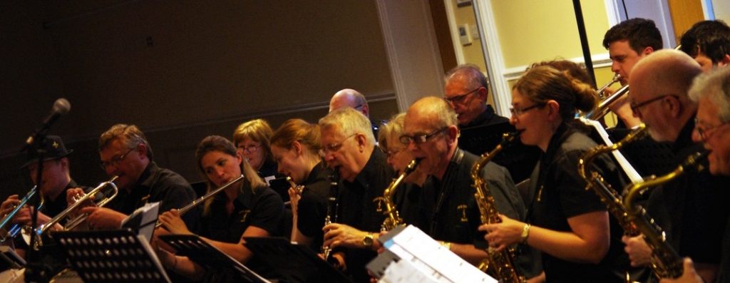 Brass band in line playing their instruments